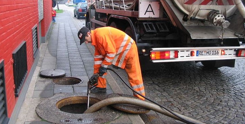 man pumping septic tank